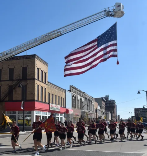 ISU ROTC cadets run Cy-Hawk game ball through Marshalltown Friday